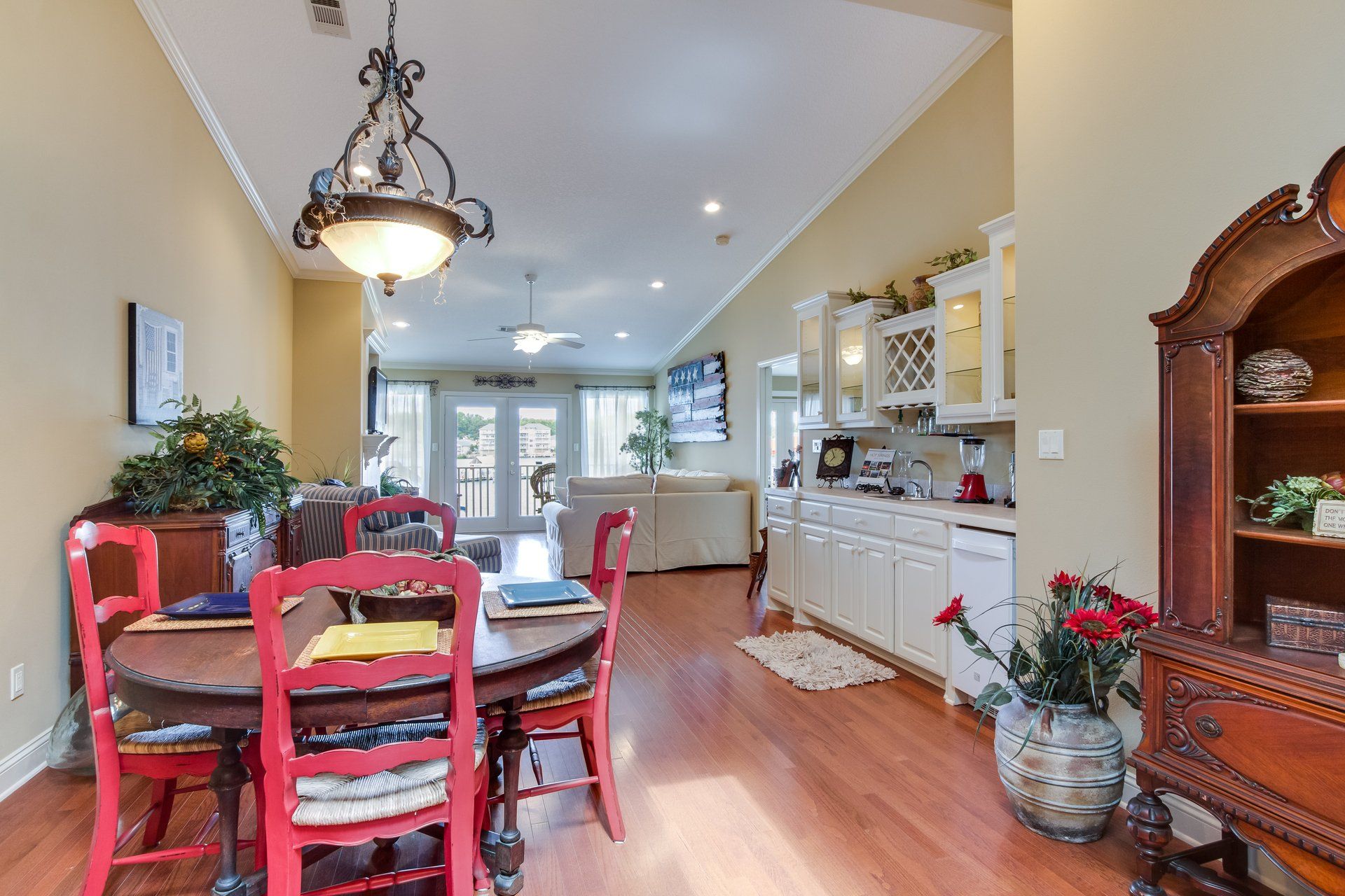 A dining room table with red chairs in a house