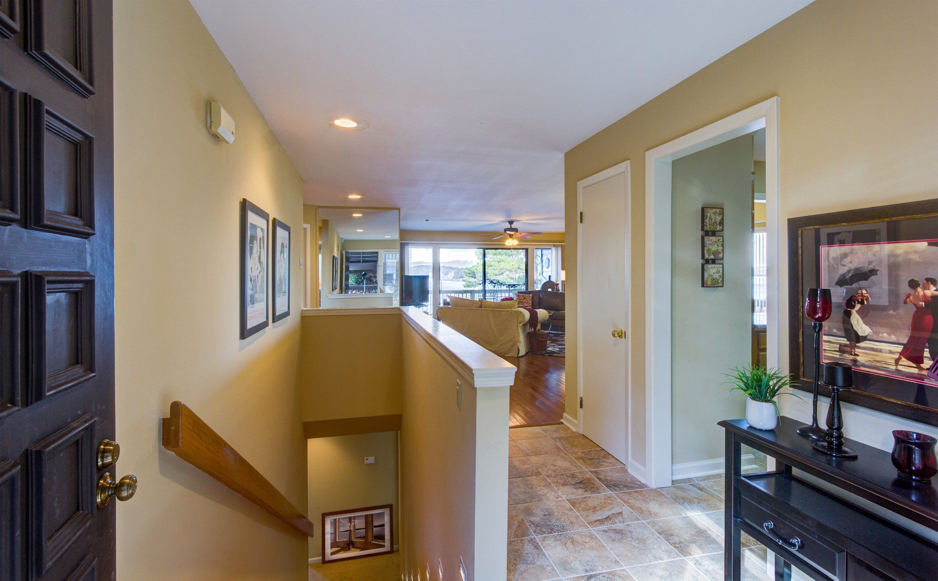 A hallway with stairs leading up to the second floor of a house.
