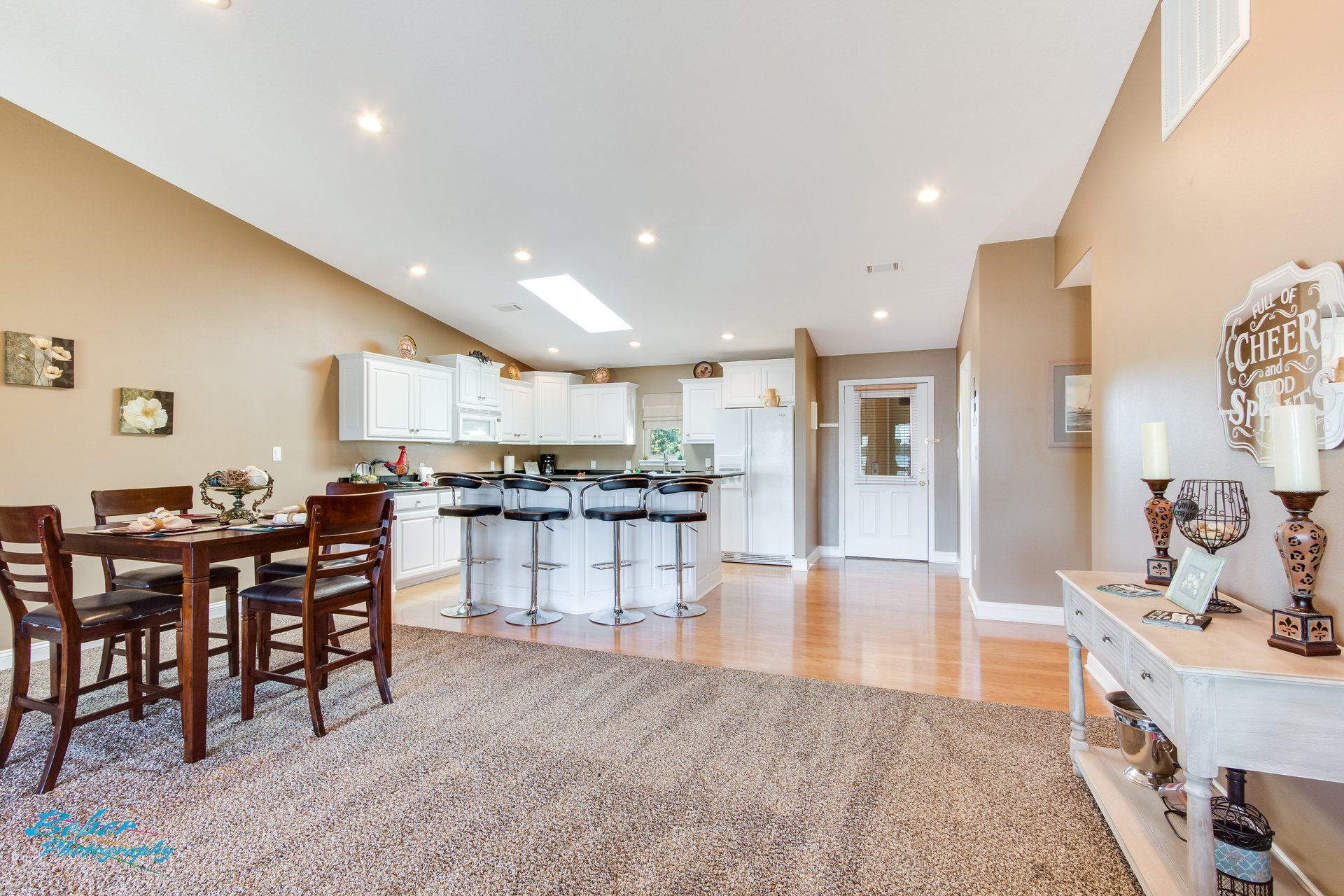 A living room with a table and chairs and a kitchen