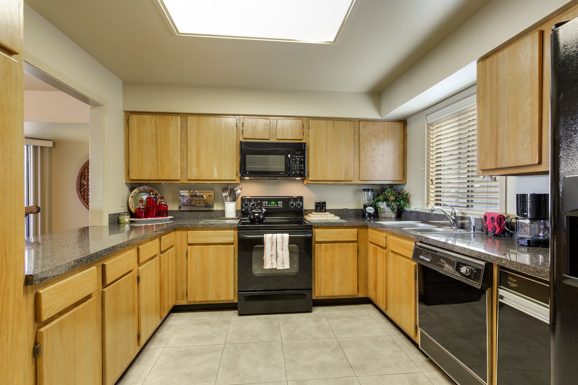 A kitchen with stainless steel appliances and wooden cabinets