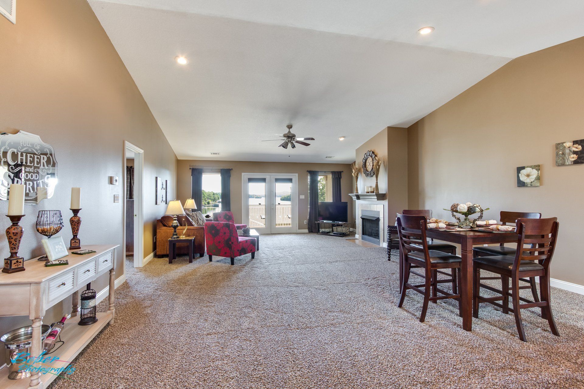 A living room with a table and chairs and a fireplace
