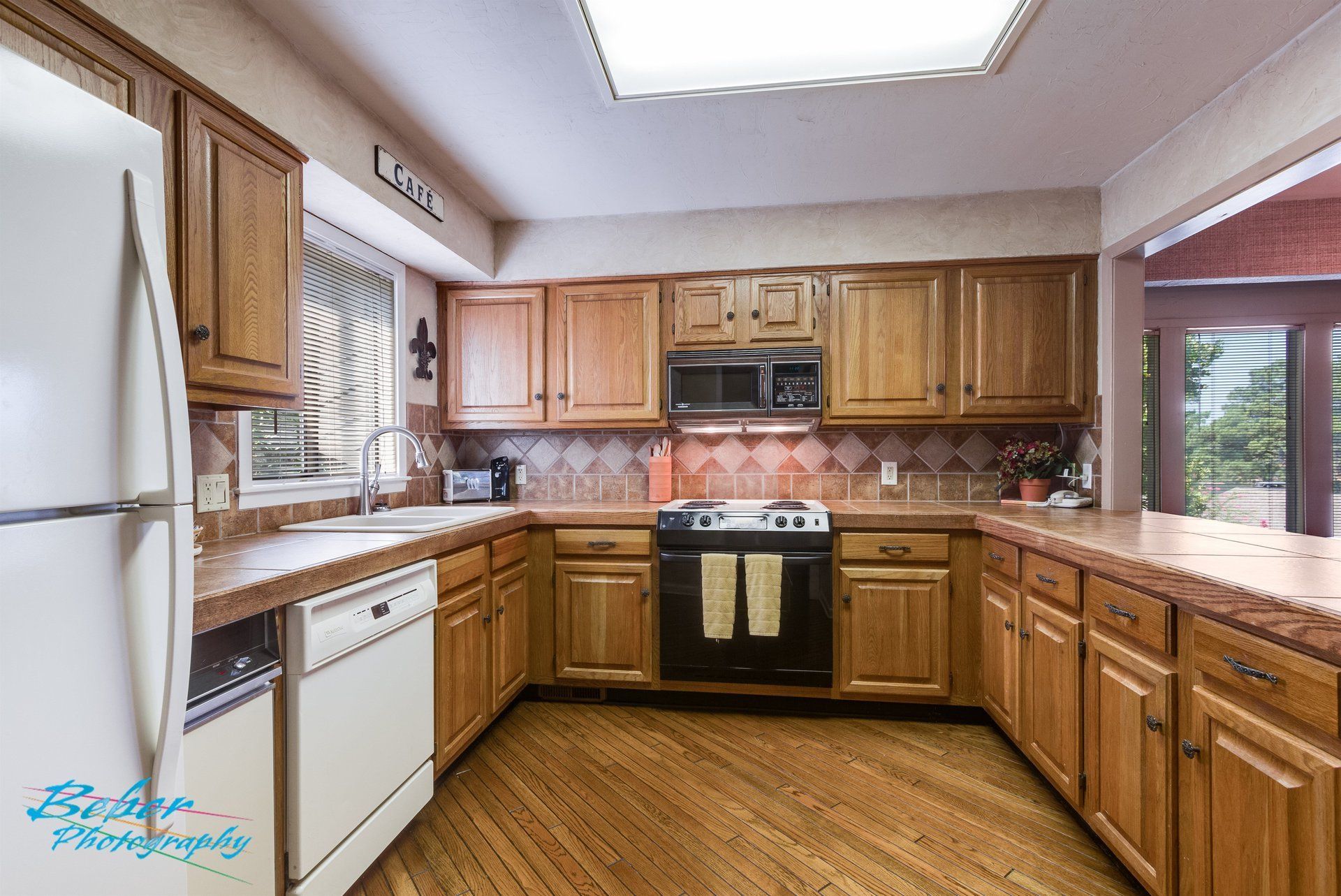 A kitchen with wooden cabinets and a white refrigerator