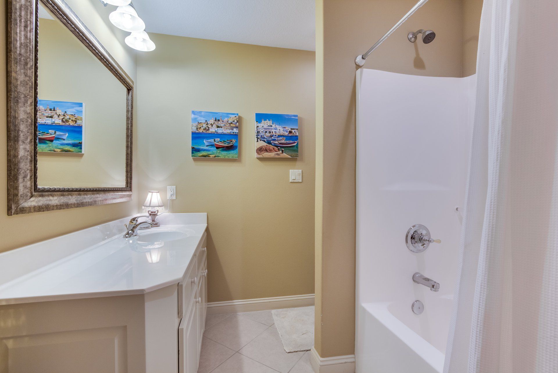 A bathroom with a tub , sink , mirror and shower.