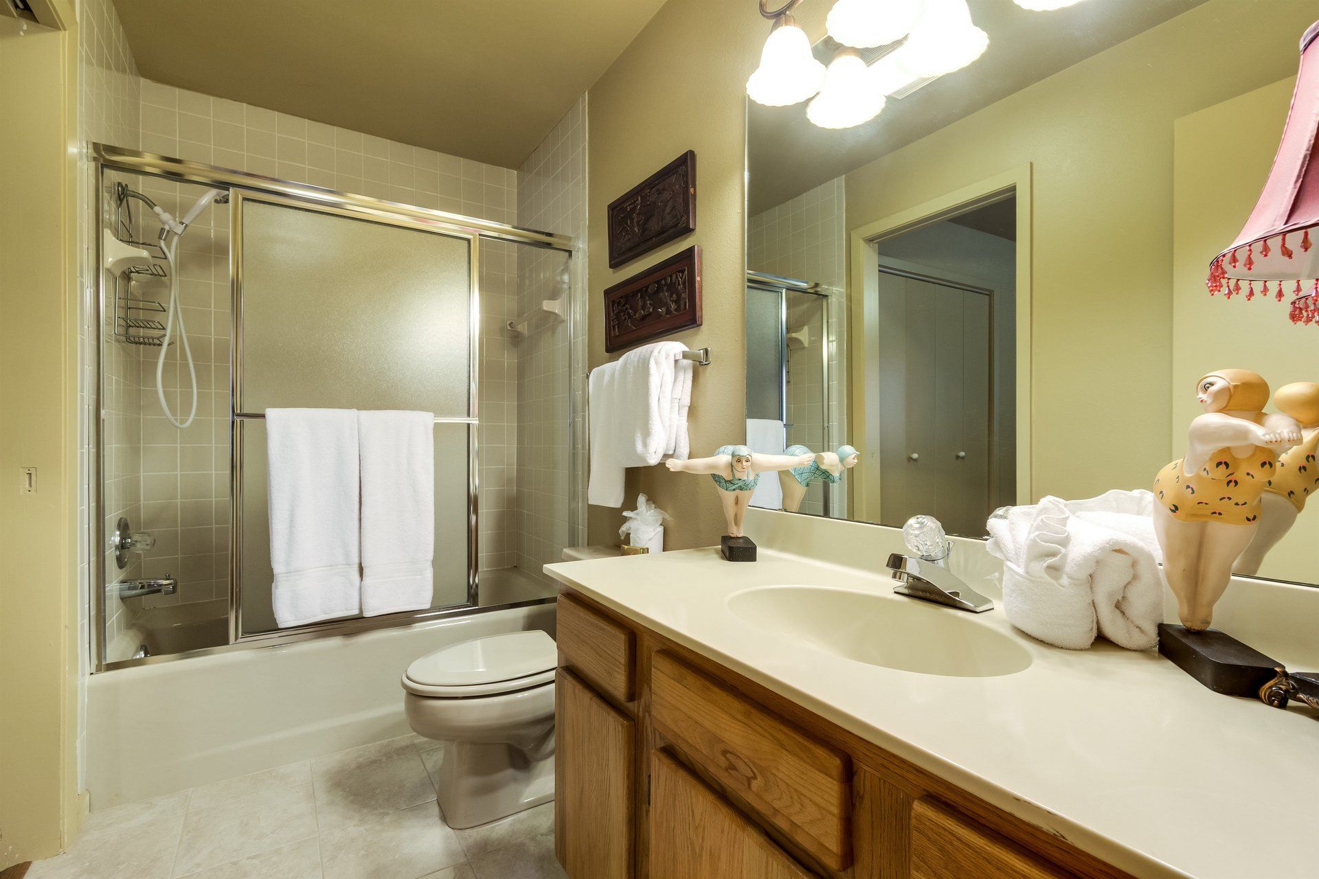 A bathroom with a toilet , sink , and shower.