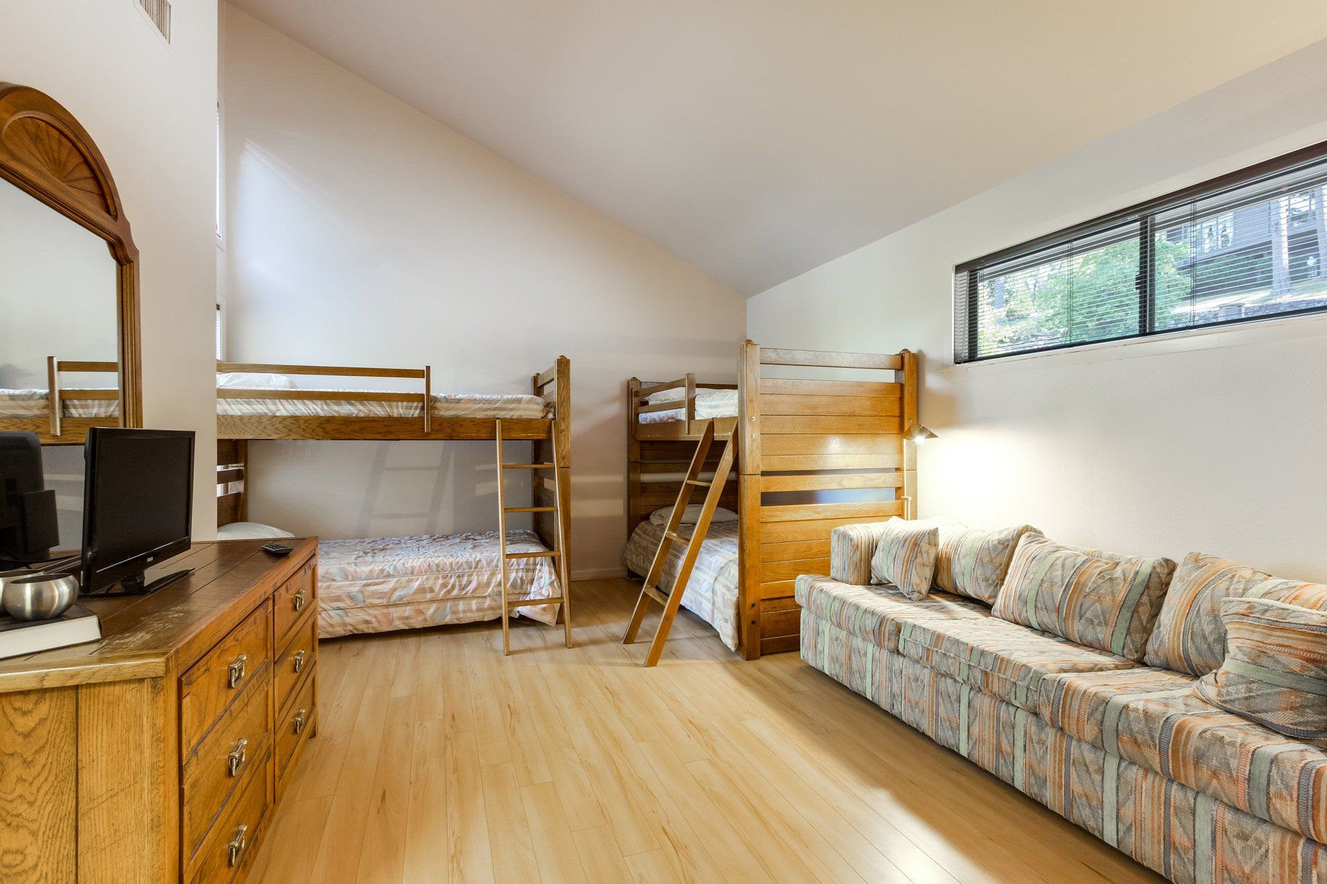 A living room with bunk beds and a couch.