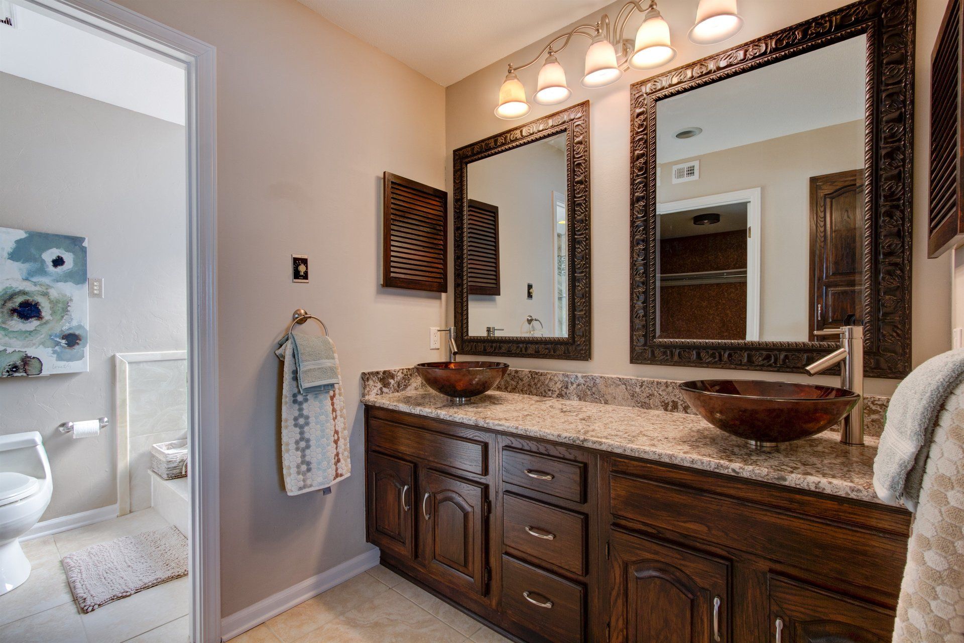 A bathroom with two sinks and two mirrors.