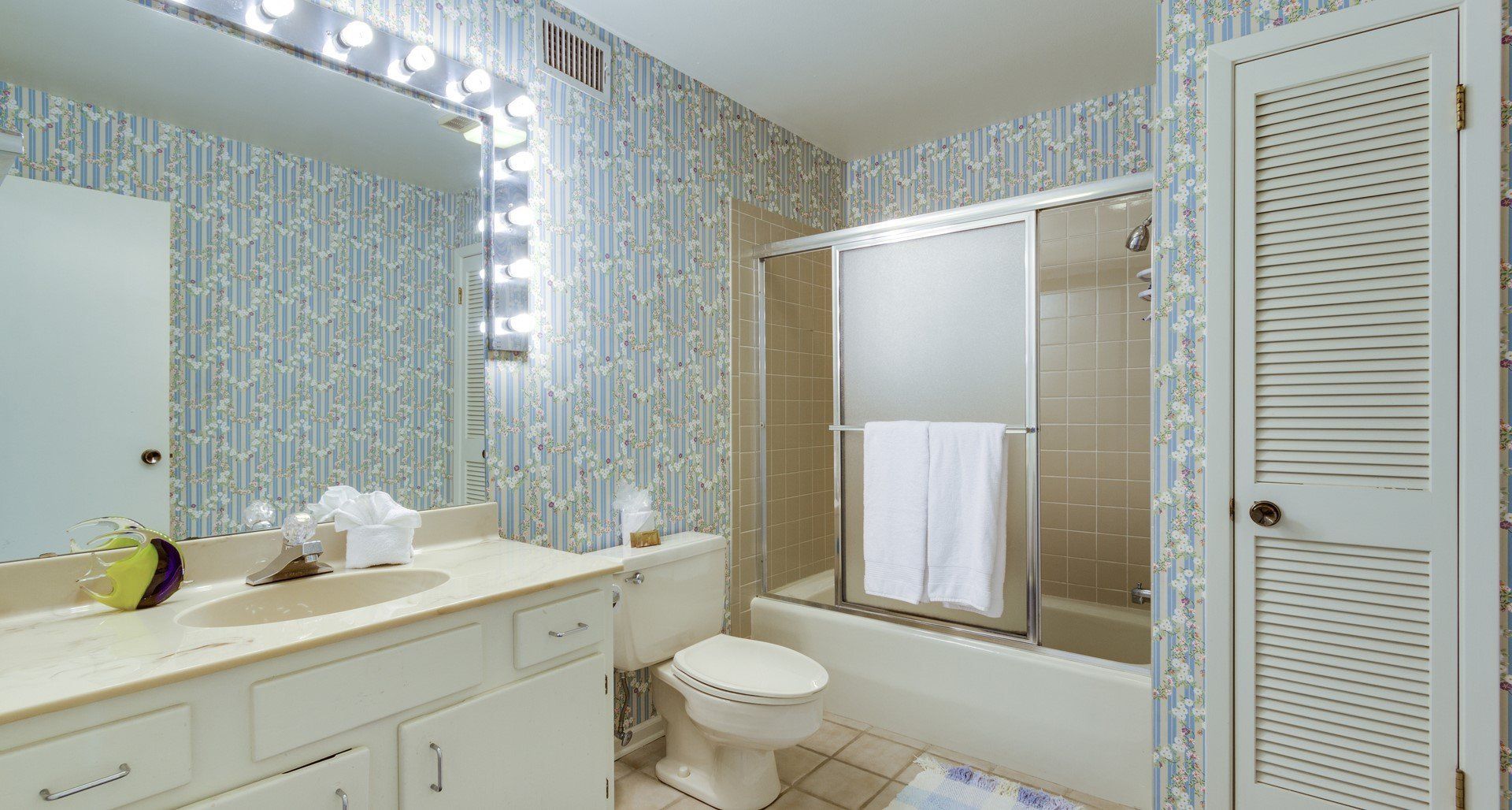 A bathroom with a toilet , sink , and shower.