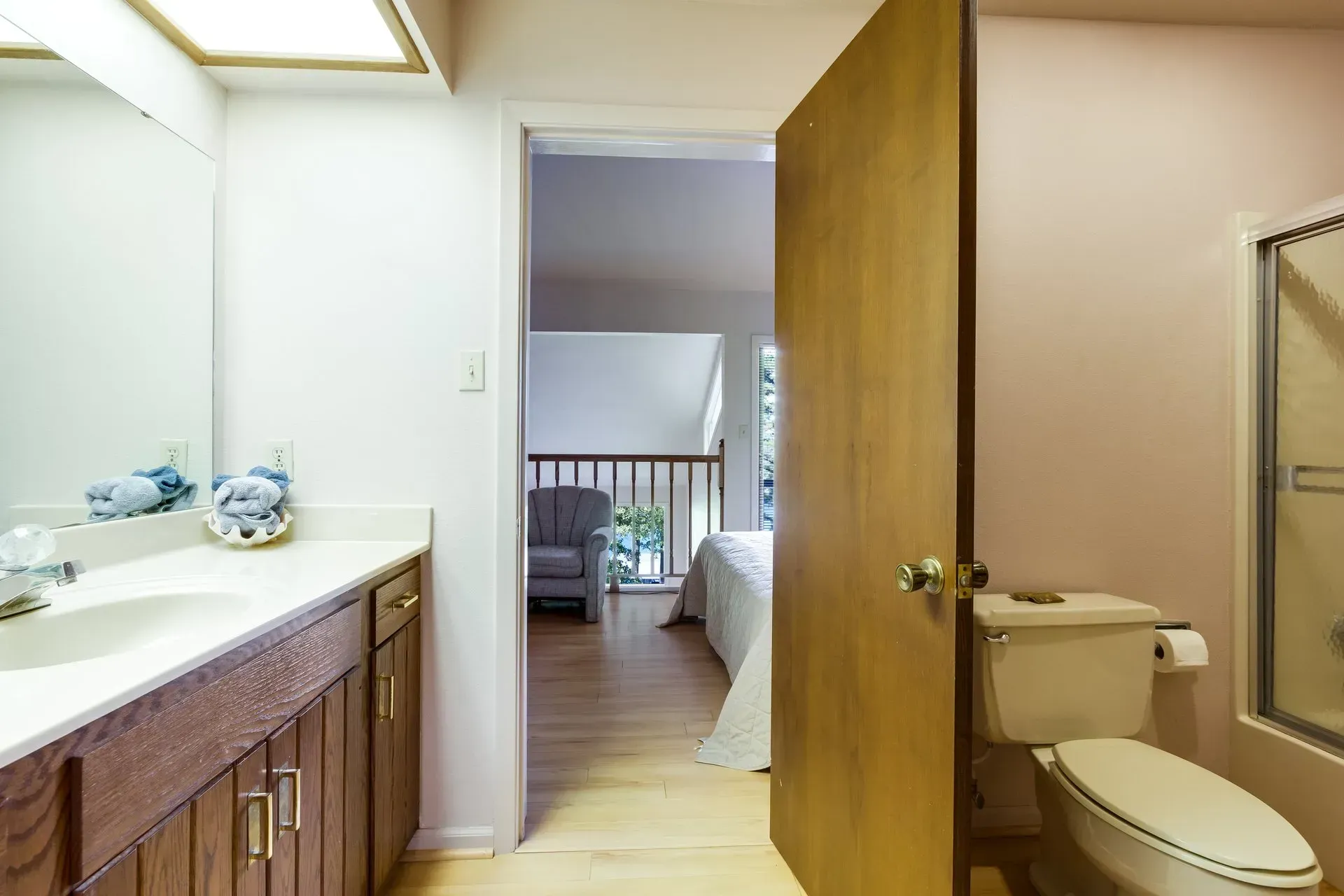 A bathroom with a toilet , sink and mirror