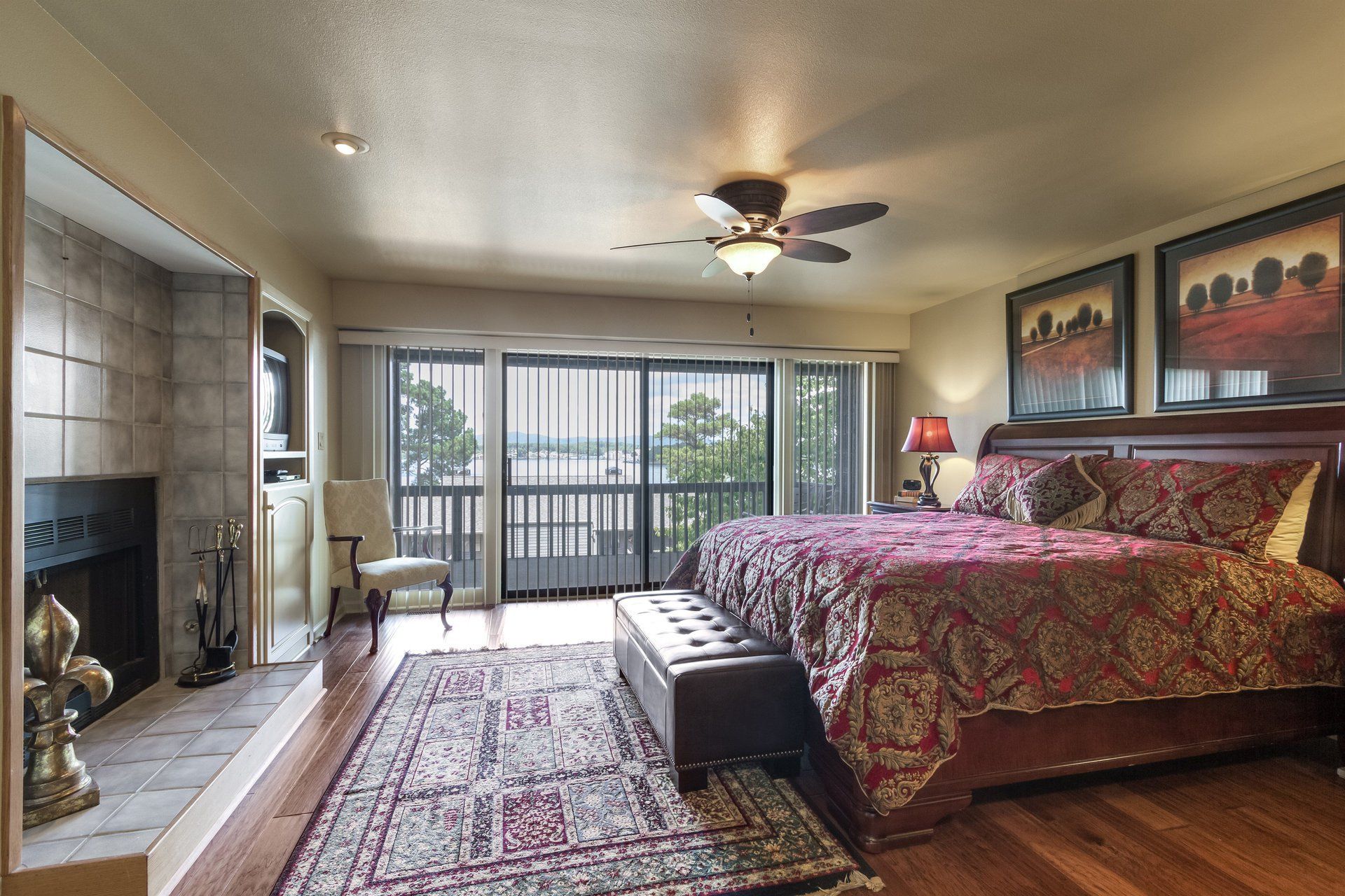 A bedroom with a large bed and a fireplace