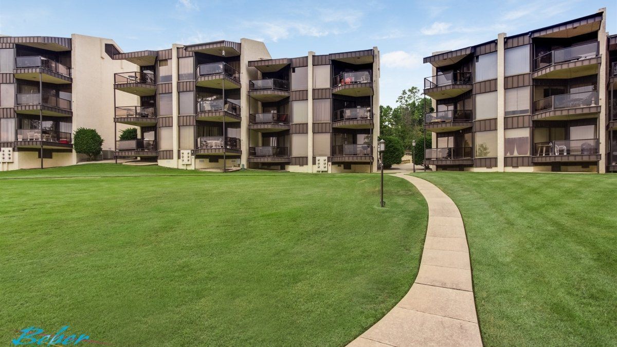 view of multiple properties and wooden walkway with benches at Willow Beach B1