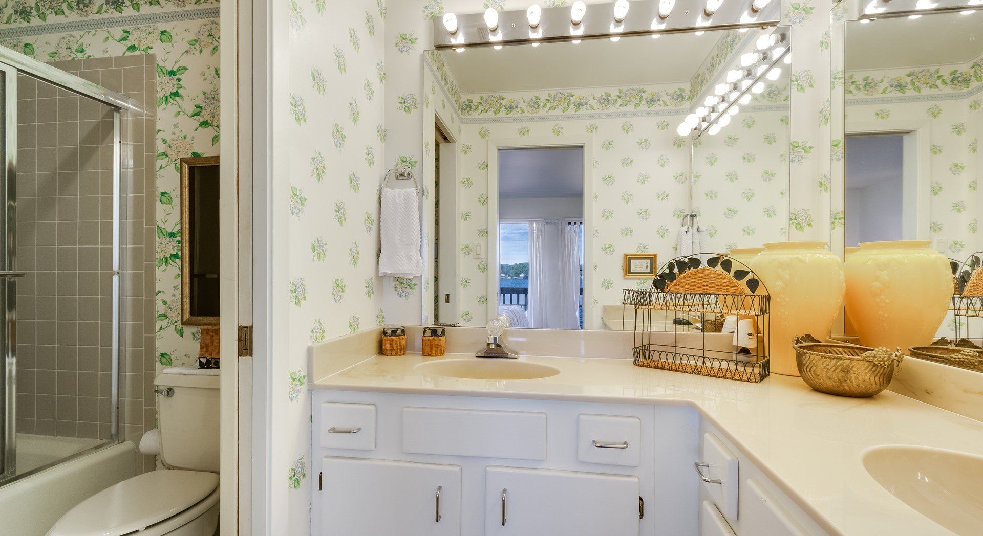 A bathroom with a toilet , sink , and mirror.