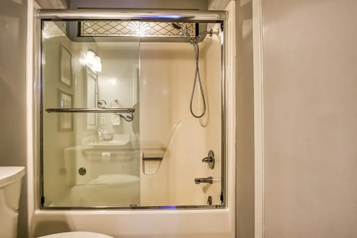 A bathroom with a tub , toilet , sink and shower.