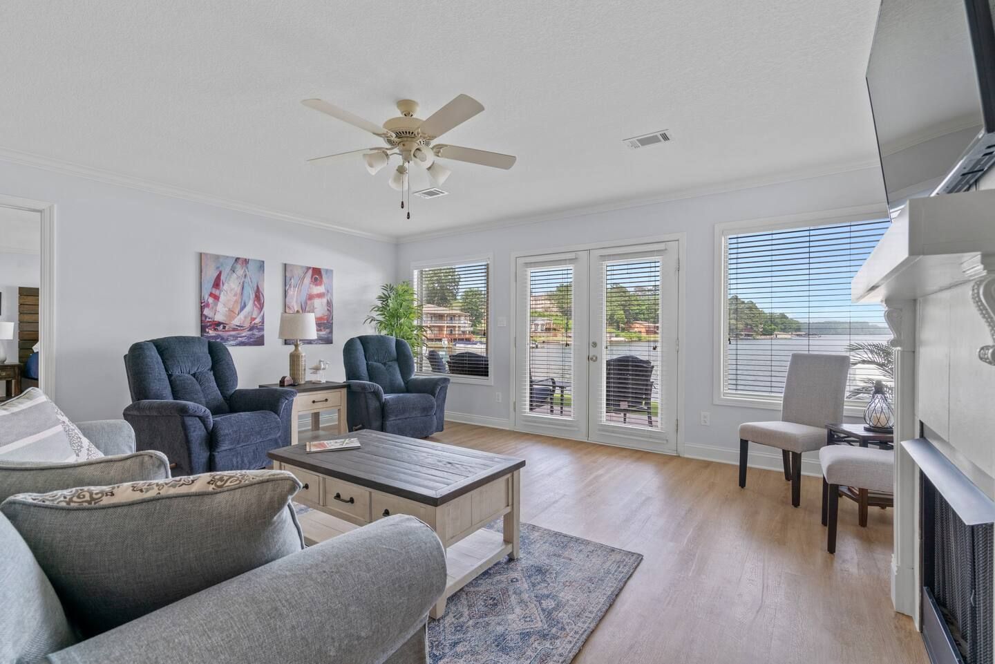 A living room with a couch , chairs , coffee table and fireplace.