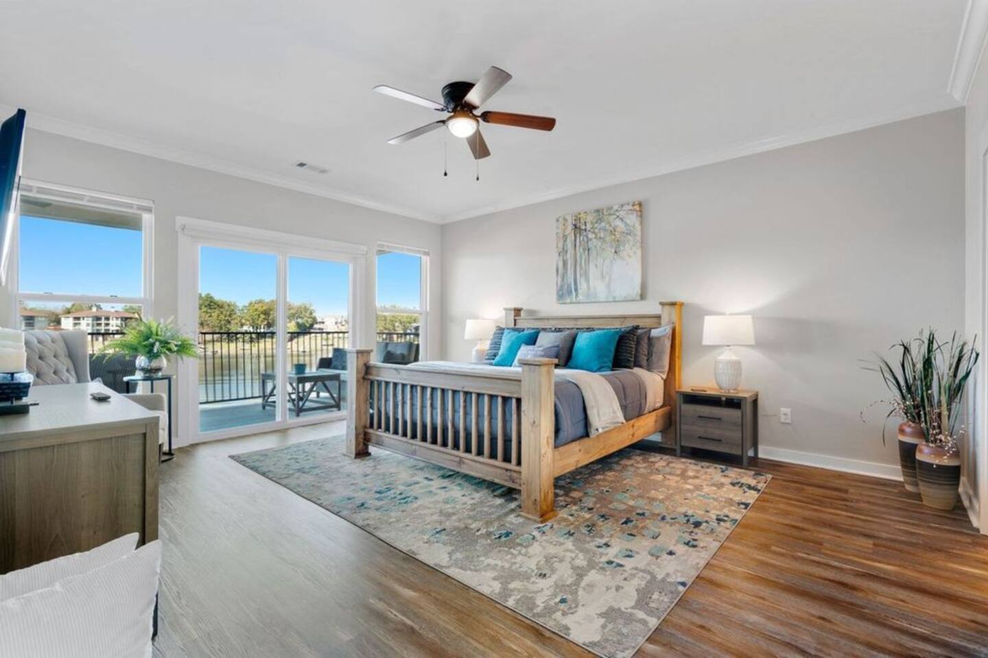 A bedroom with a large bed and a ceiling fan.