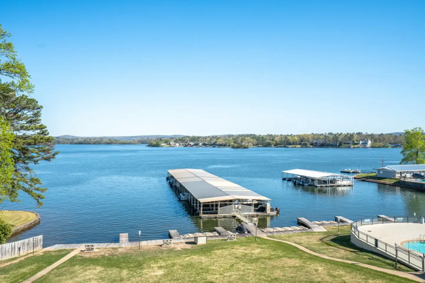 An aerial view of a large body of water with a dock in the middle of it.