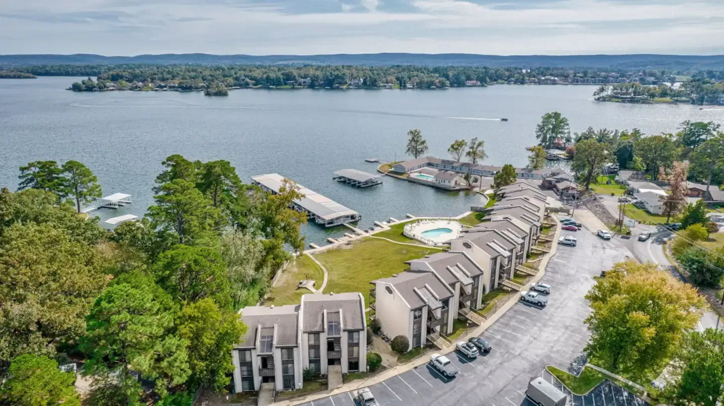 An aerial view of a lake surrounded by buildings and trees.