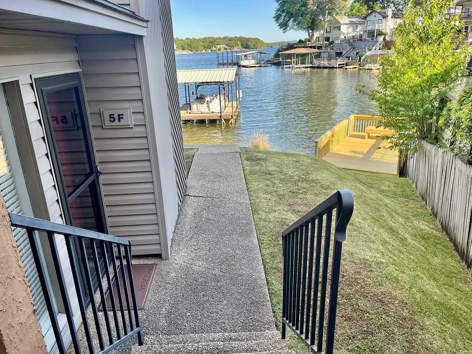 A staircase leading up to a house next to a body of water.