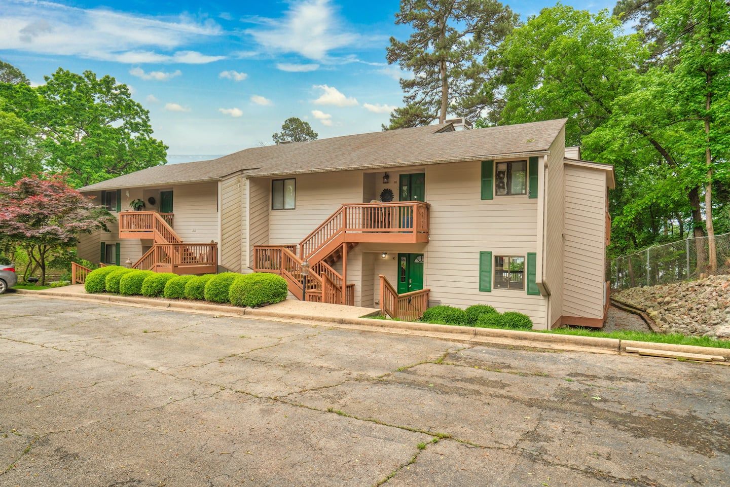 A large apartment building with stairs and a car parked in front of it.