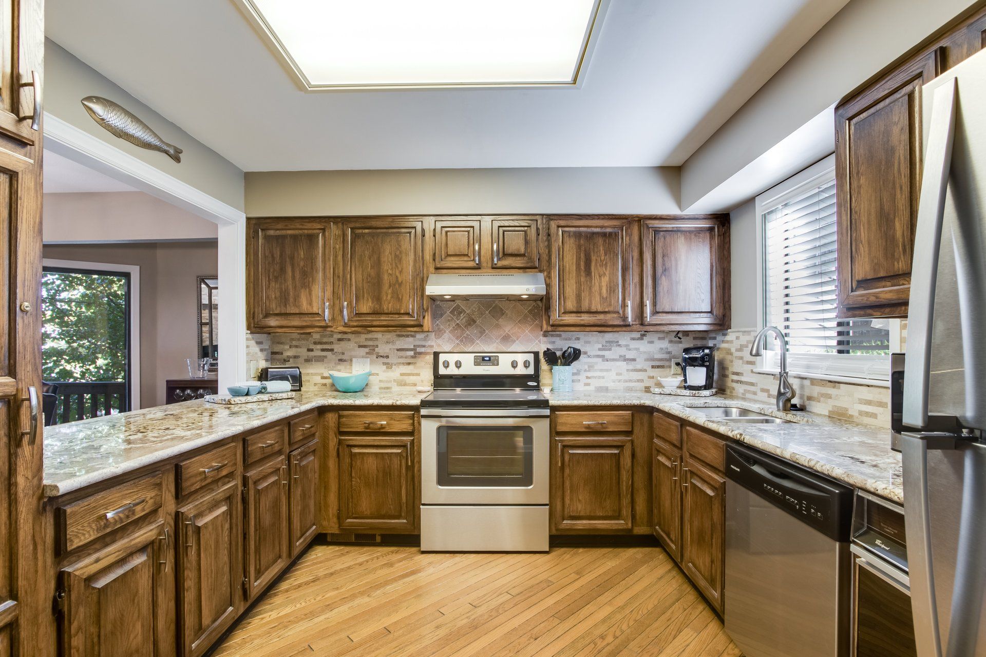 A kitchen with wooden cabinets and stainless steel appliances