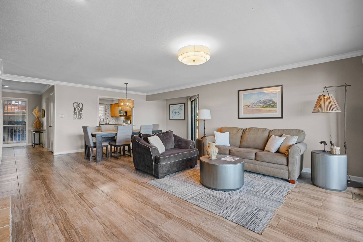 A living room with a couch , chair , table and rug.