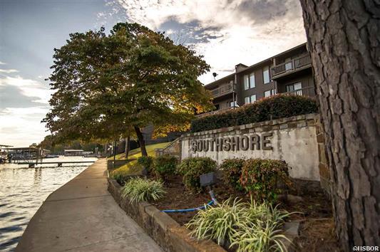 A building with a sign that says southshore is next to a body of water.