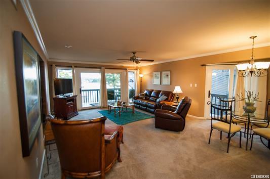 A living room with a couch and chairs and a television