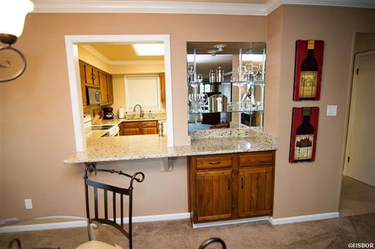 A dining room with a bar and a chair