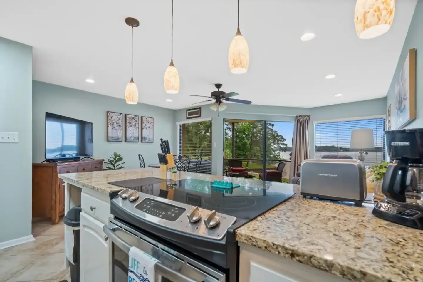 A kitchen with a stove , oven , toaster , and coffee maker.