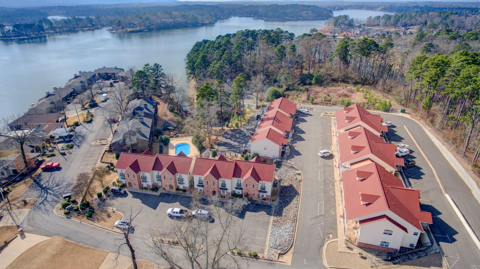 An aerial view of a row of houses next to a lake.
