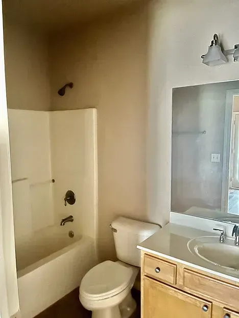 A bathroom with a toilet , sink , bathtub and shower.