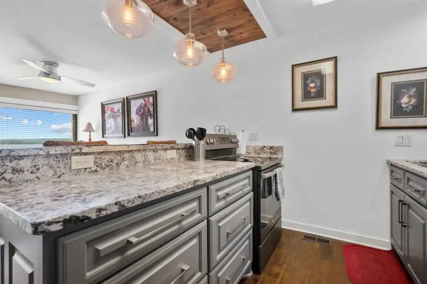 A kitchen with granite counter tops and stainless steel appliances.