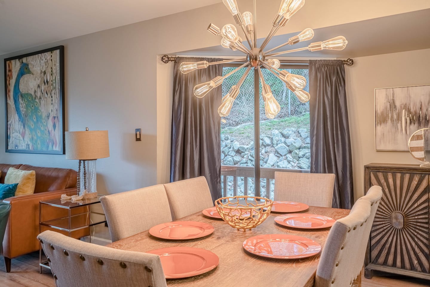 A dining room with a table and chairs and a chandelier.