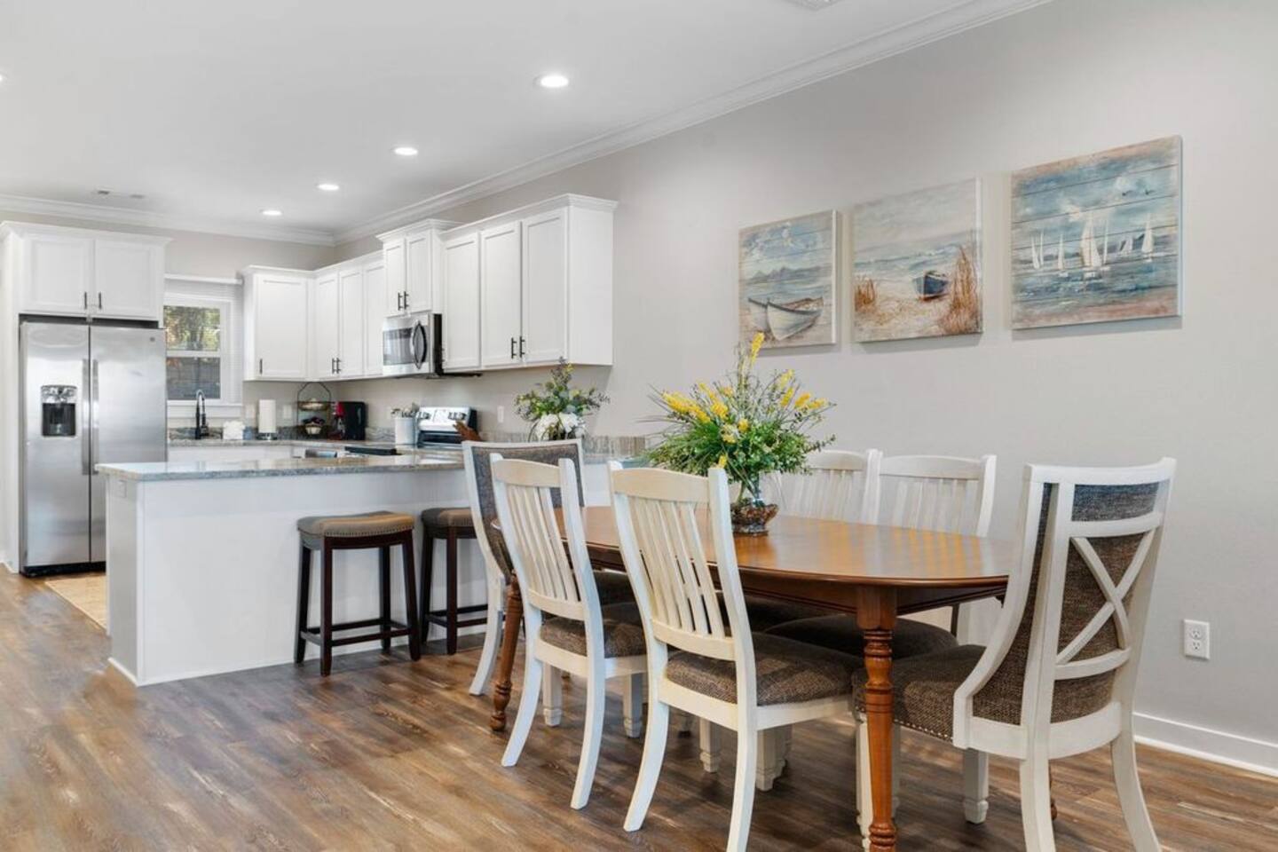 A kitchen and dining room in a house with a table and chairs.