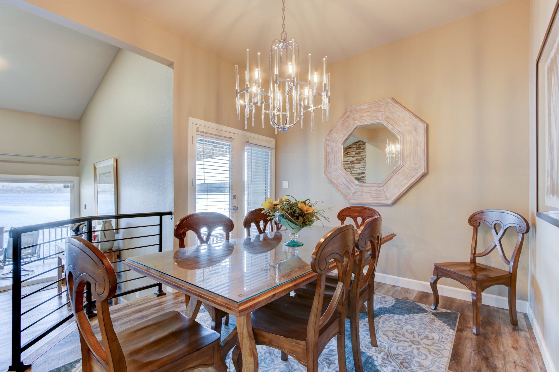 A dining room with a table and chairs and a chandelier.
