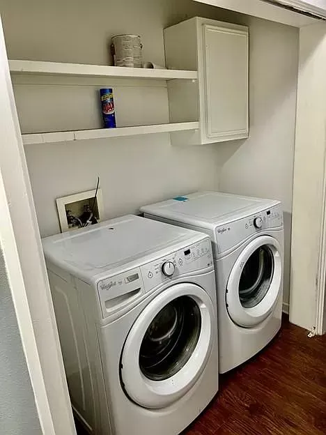 There are two washers and dryers in the laundry room.