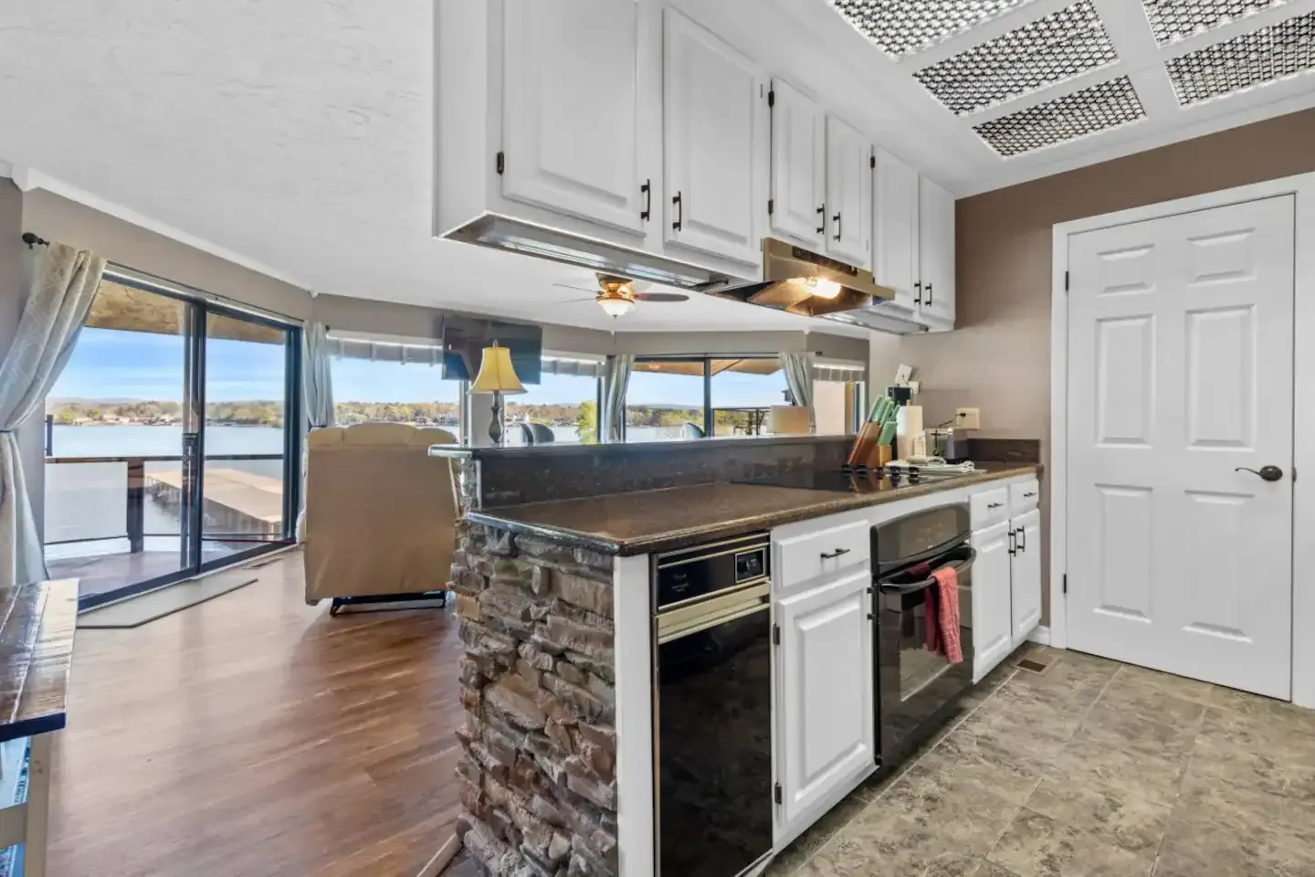 A kitchen in a house with a large island in the middle of the room.