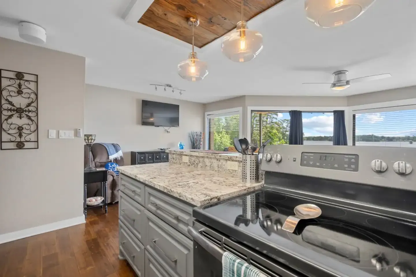 A kitchen with a stove and a large island in the middle of the room.
