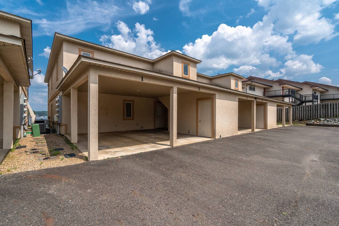 A row of houses with a parking lot in front of them