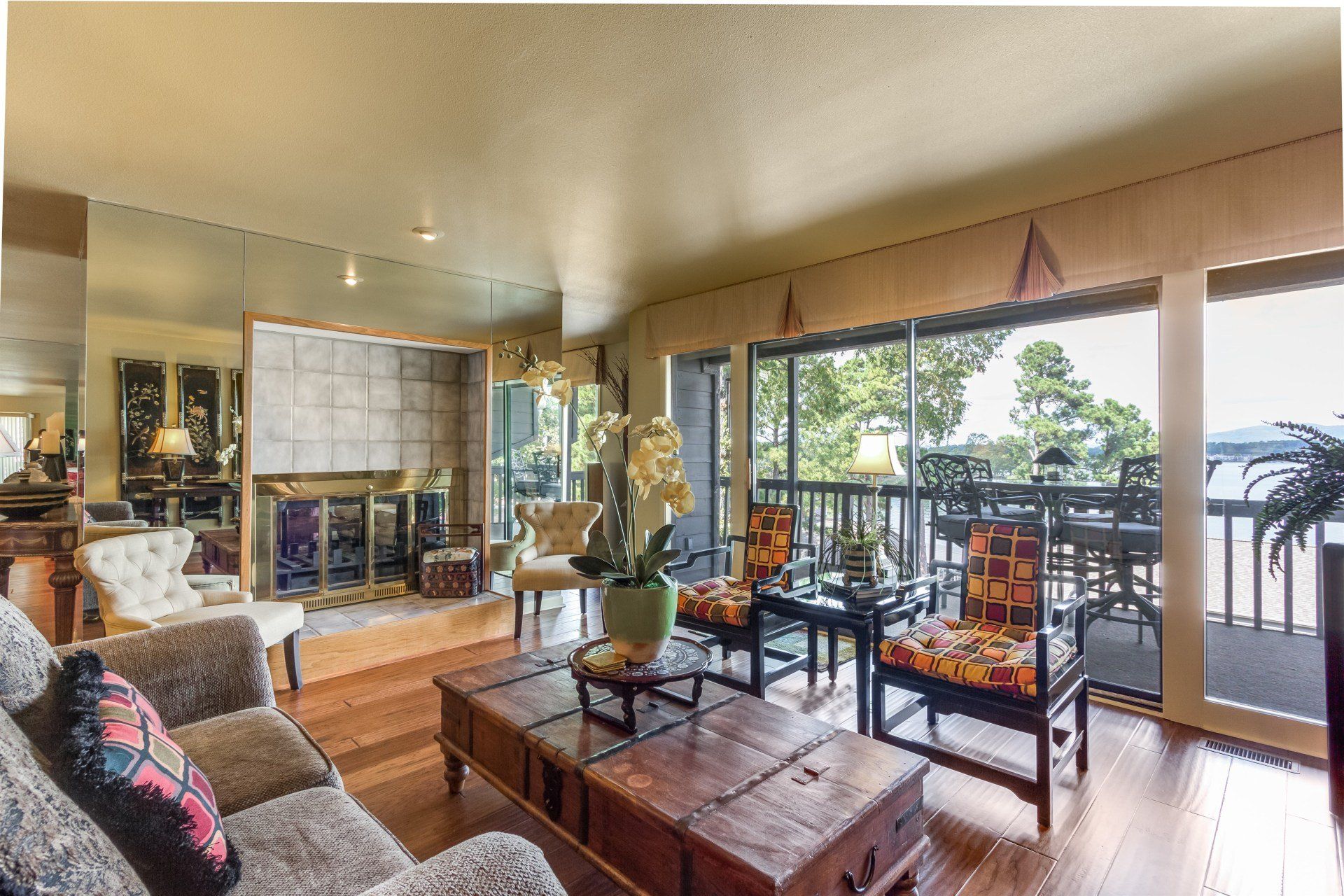 A living room with a couch and chairs and a large window
