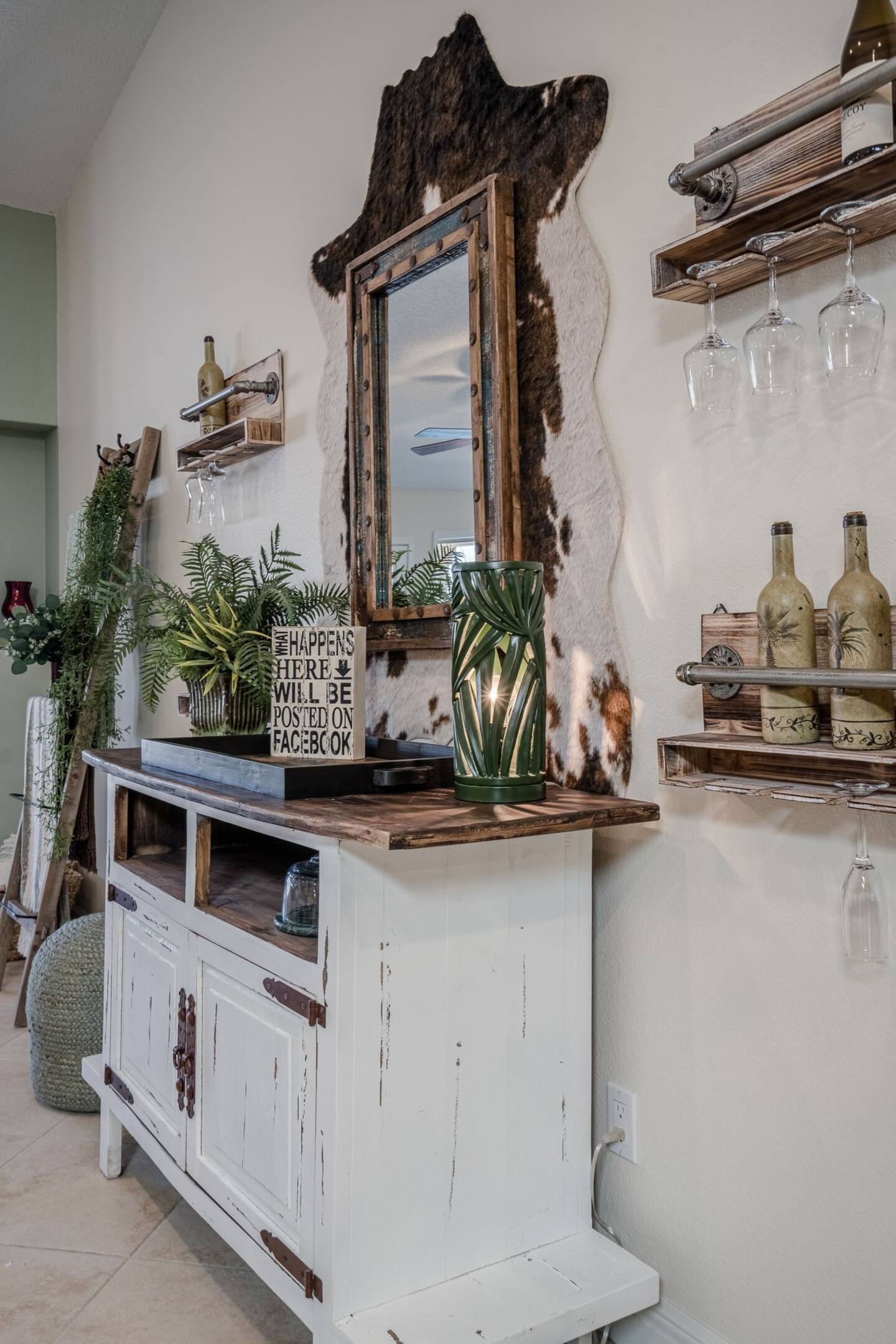 A white dresser with a mirror on top of it in a room.
