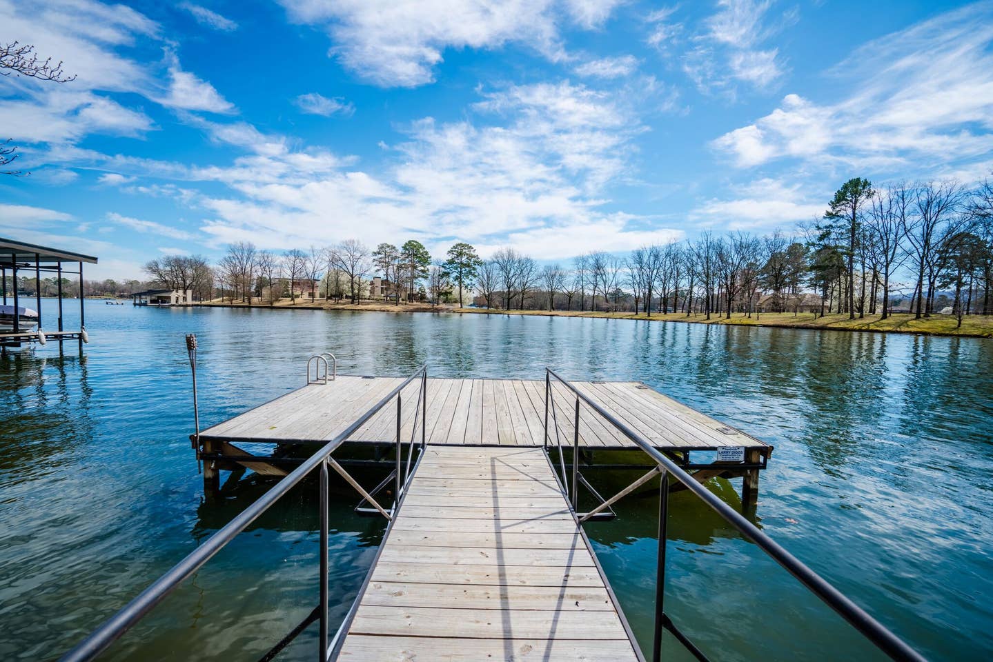 There is a dock in the middle of a lake.