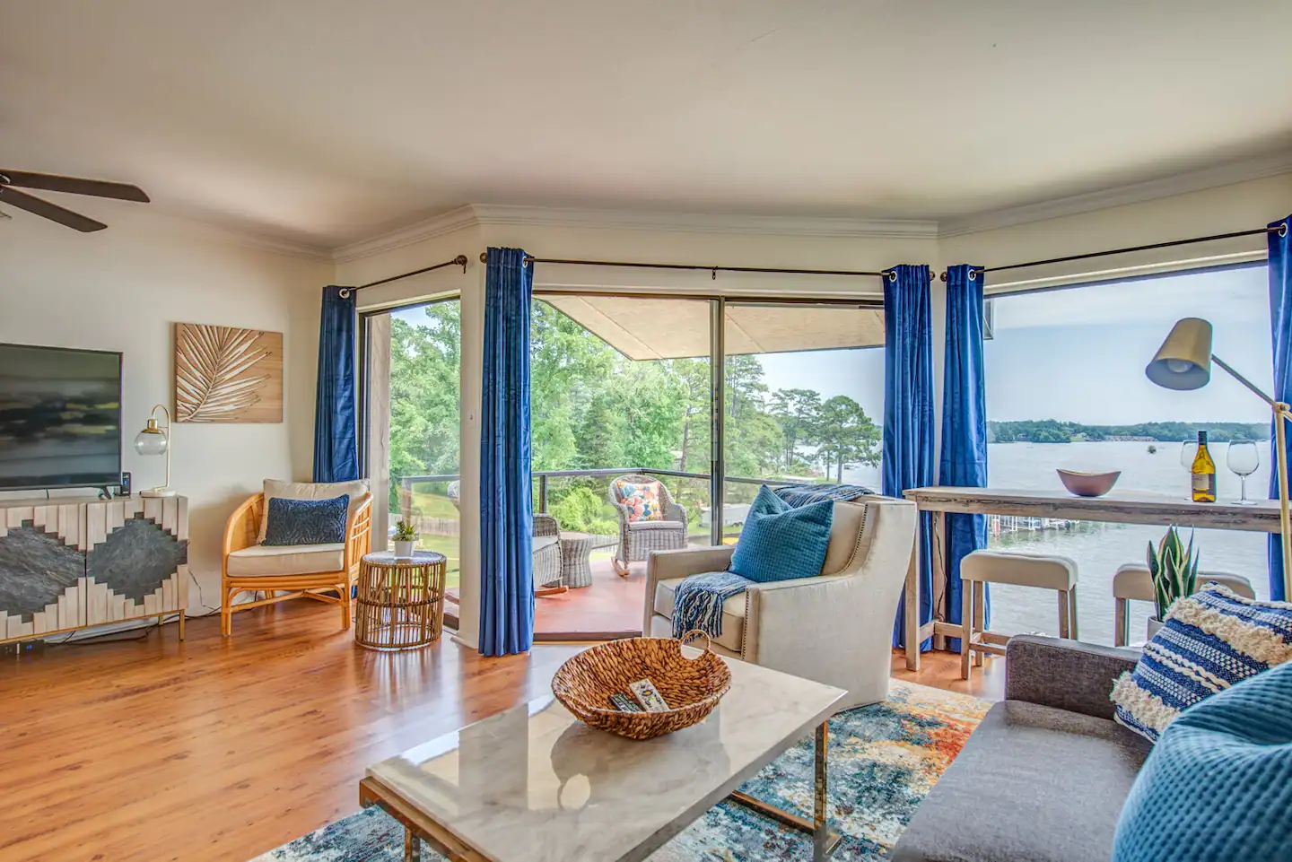 A living room with a couch , chairs , table and television.