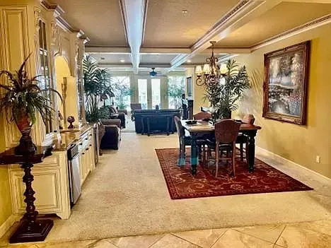 A large living room with a dining room table and chairs.