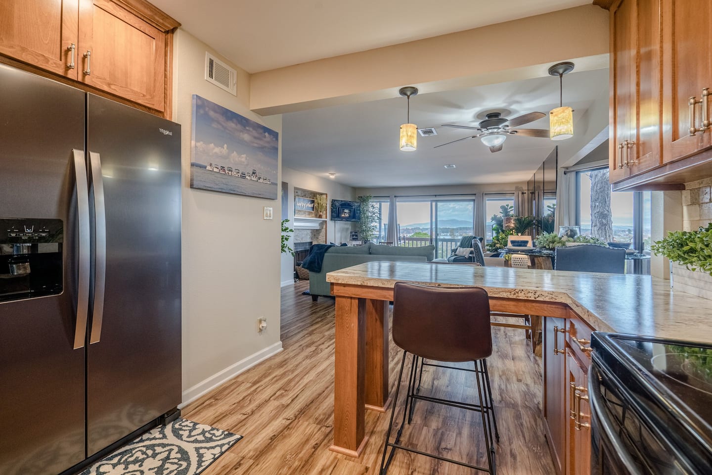 A kitchen with a refrigerator , stove , table and chairs.
