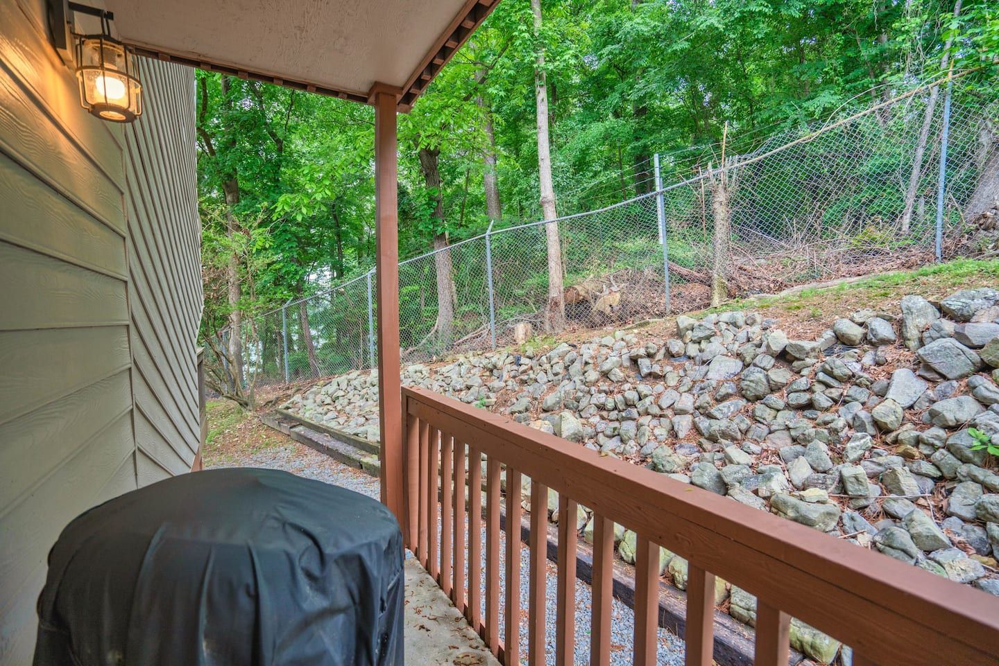 There is a grill on the porch of a house.