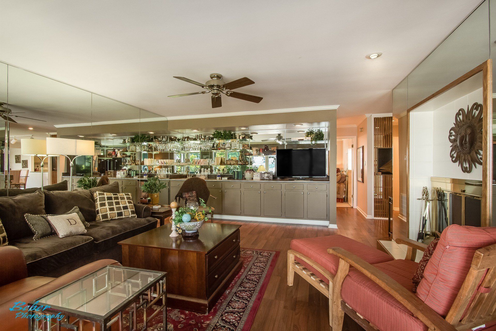 A living room filled with furniture and a ceiling fan.