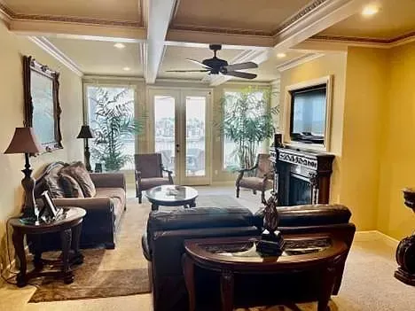 A living room filled with furniture and a ceiling fan.