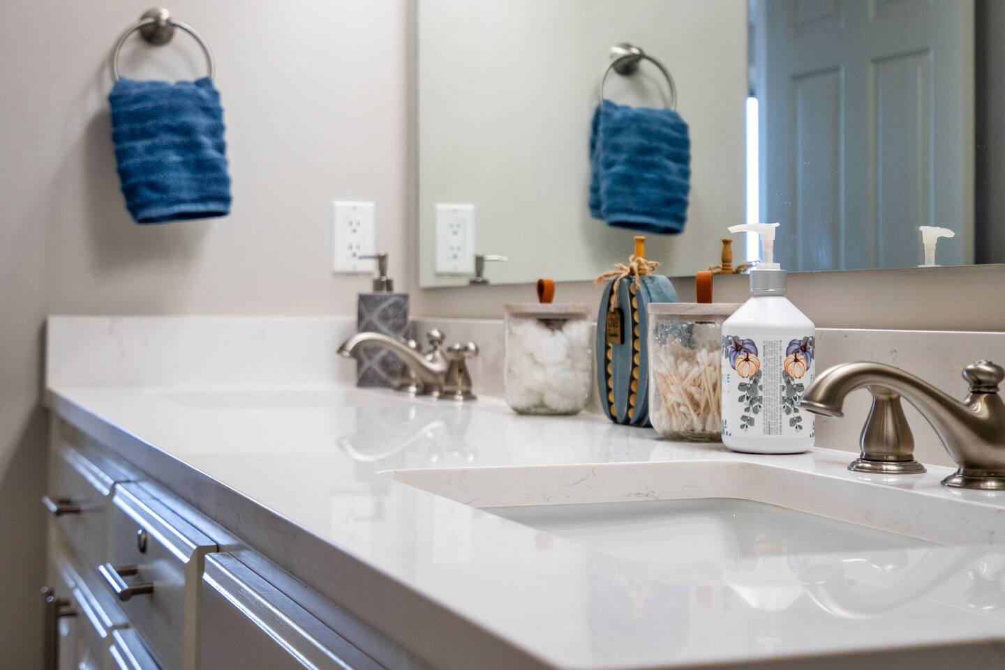 A bathroom with two sinks and a mirror.