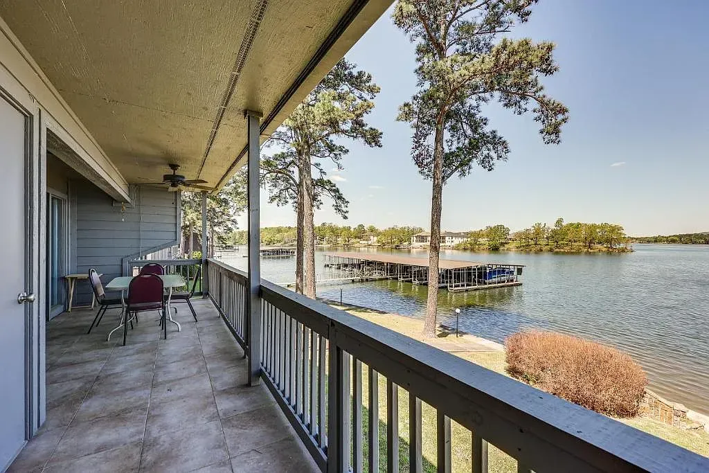 A balcony with a view of a lake and trees