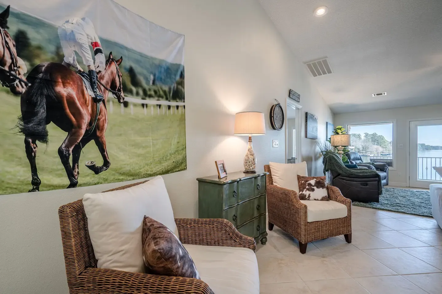 There is a picture of a horse on the wall in the living room.